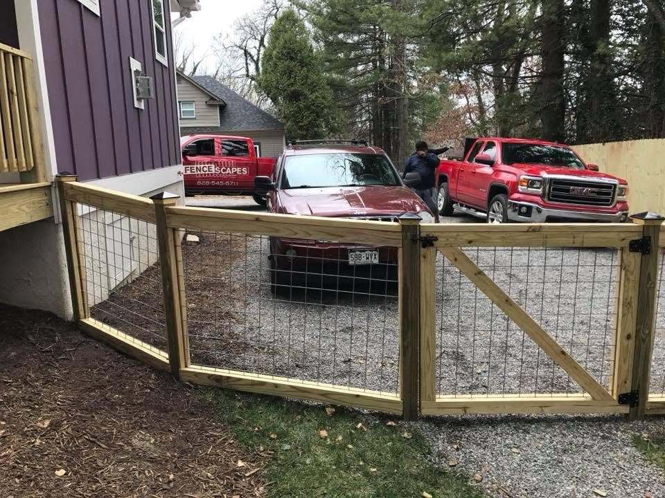 Wood-frame fence with wire mesh and a matching gate